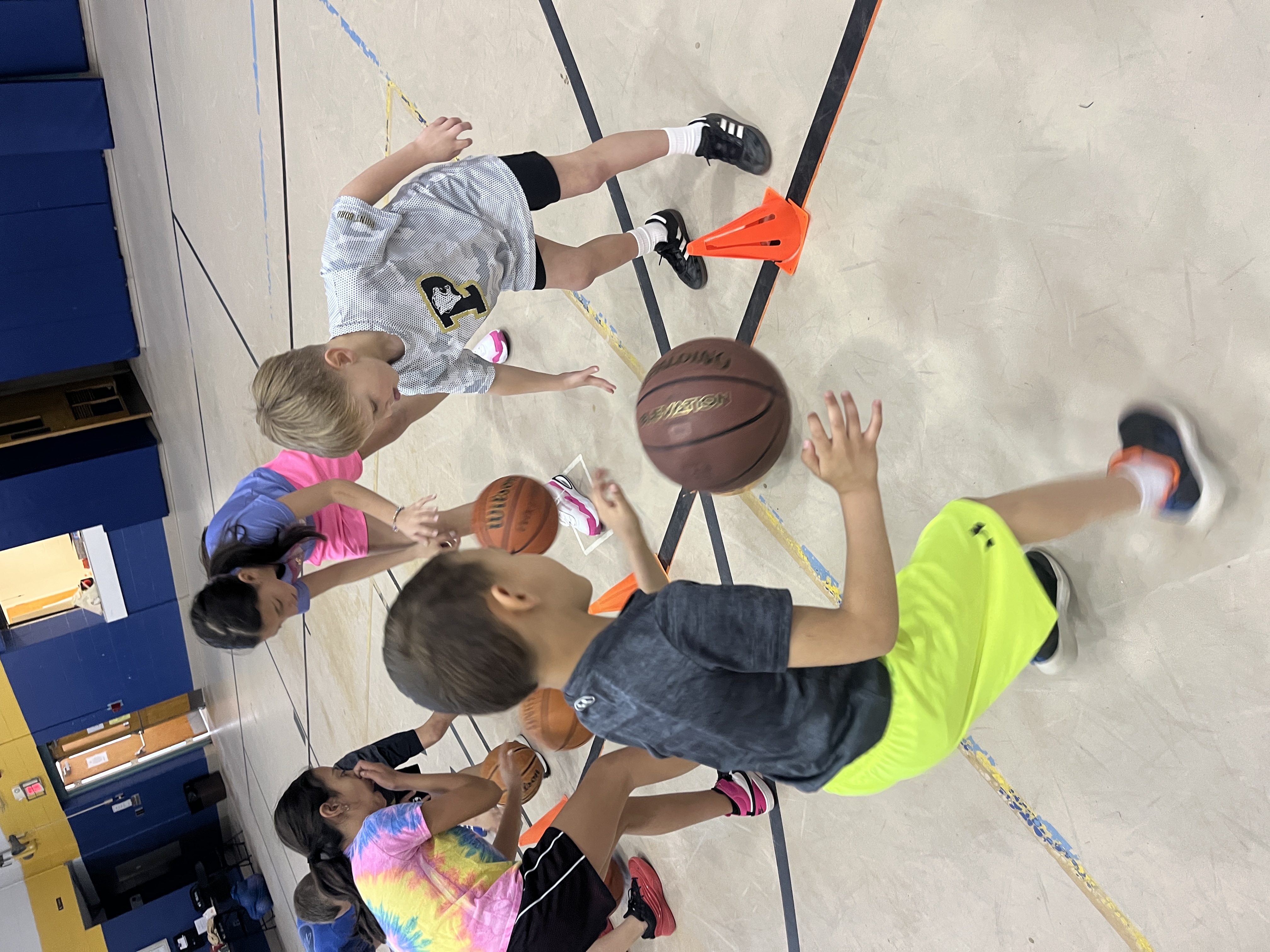 Young campers practicing ball handling together