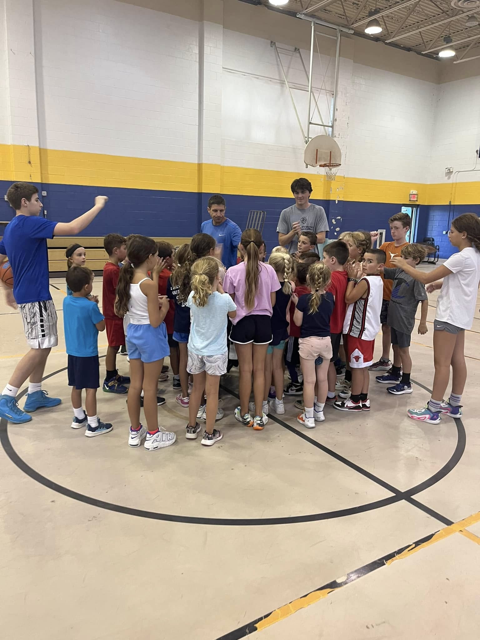 The whole camp huddled around Coach Nick at St. Denis Gym