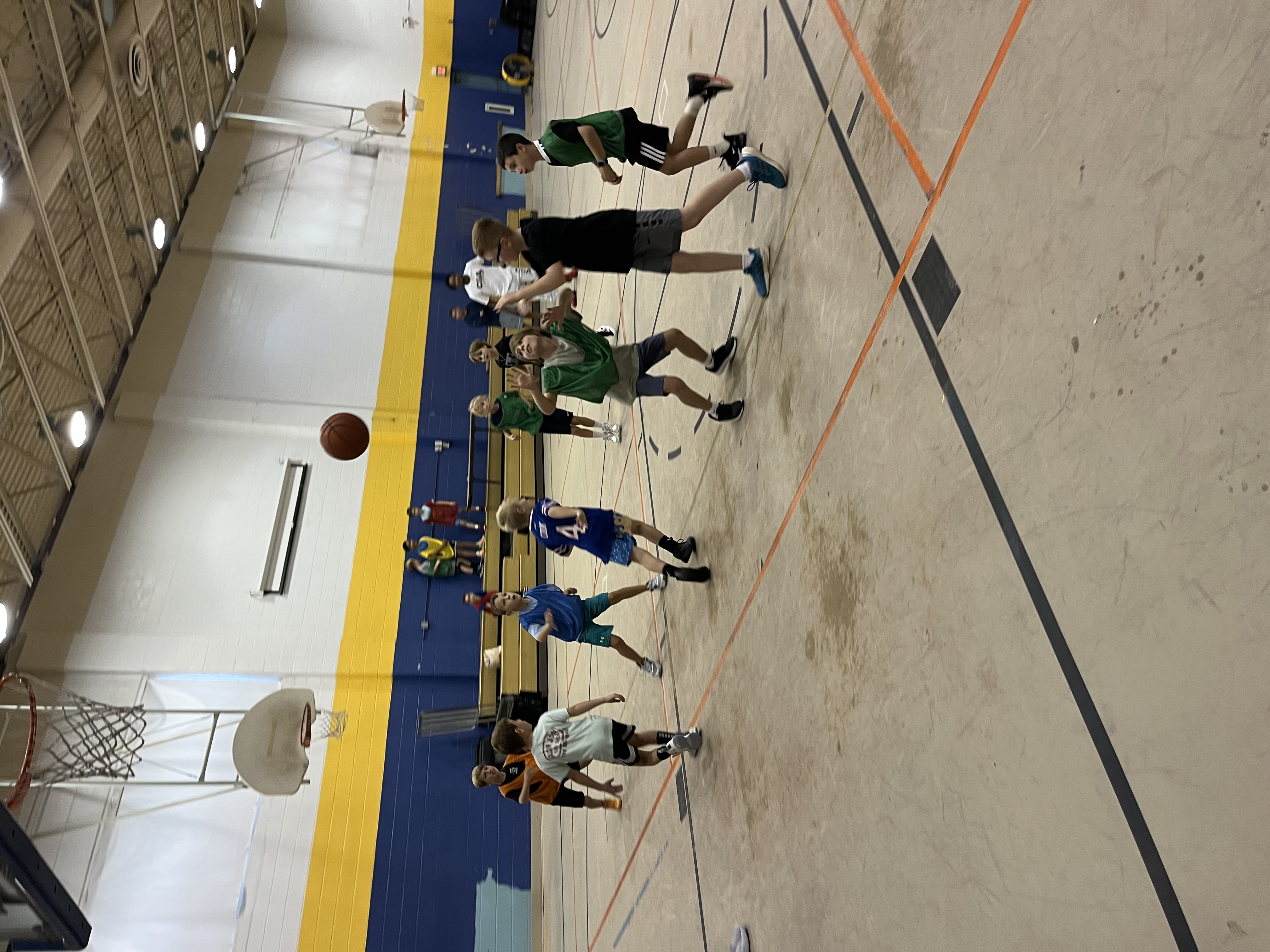Campers scrimmaging across the full court at St. Denis Gym