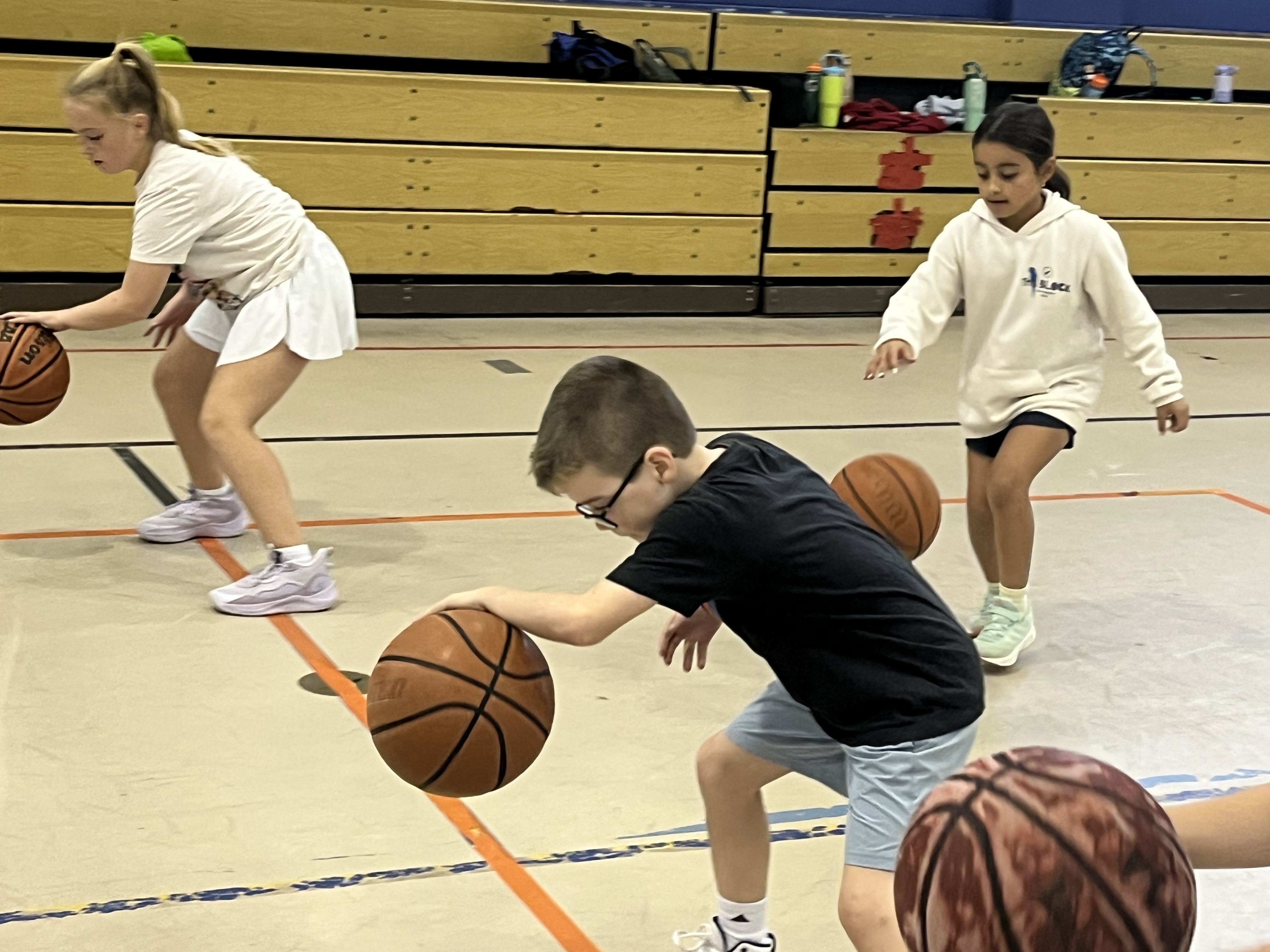 A camper focused on a dribbling drill
